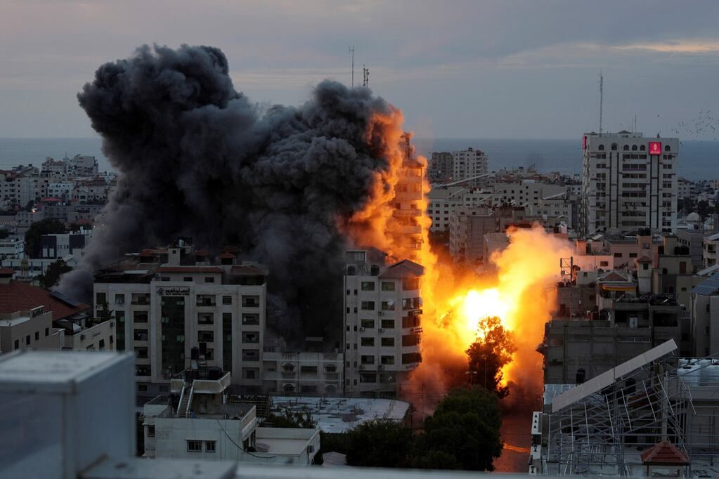 Una bola de fuego y humo se eleva a partir de una explosión en una torre de apartamentos palestina luego de un ataque aéreo israelí en la ciudad de Gaza. (AP)