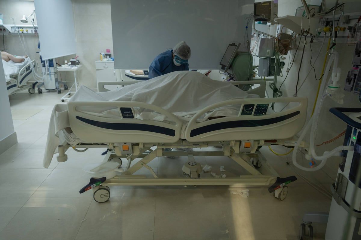 La enfermera Erica Blanco tapando un paciente fallecido, fue en mayo cuando todas las camas de terapia de los hospitales estaban ocupadas.
Foto: Ignacio Blanco

