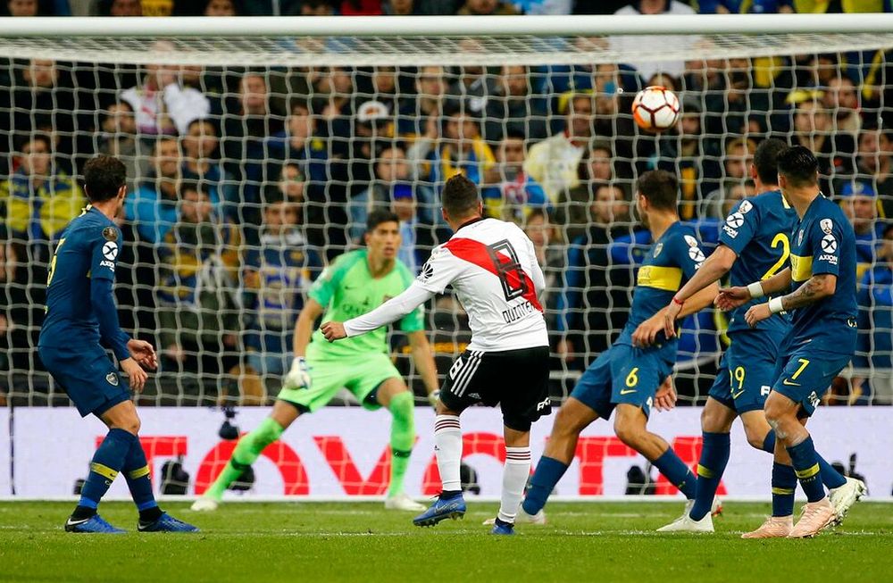 Juan Quintero of Argentinas River Plate, 8, scores his sides second goal against Argentinas Boca Juniors during extra time of the Copa Libertadores final soccer match at the Santiago Bernabeu stadium in Madrid, Spain, Sunday, Dec. 9, 2018. (AP Photo/Andrea Comas)