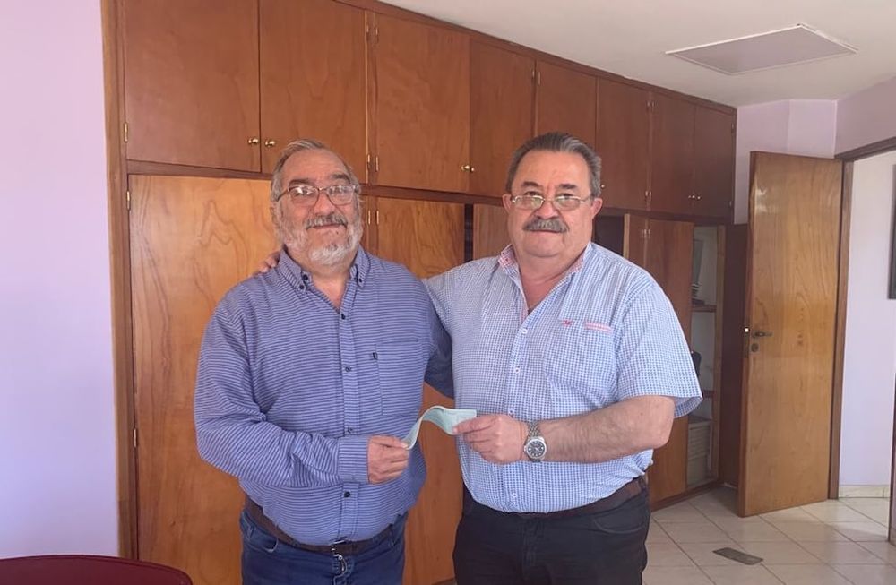 David Berbel, presidente de Guaymallén, recibe el cheque por parte de su colega de Gutiérrez, Carlos Quiroga. Así, el Cacique podrá reponer las camisetas que fueron sustraídas el sábado pasado en el estadio celeste. / Gentileza.