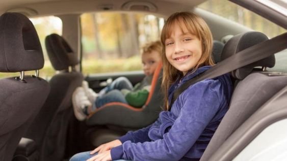 Niños seguros en el auto rumbo a la escuela