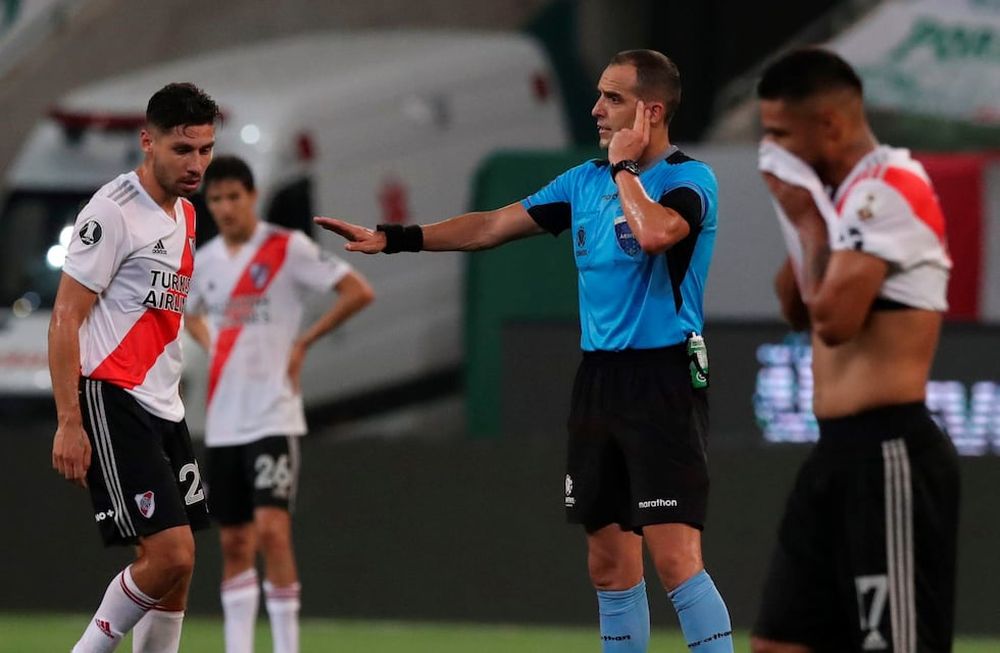 El árbitro uruguayo Esteban Ostojich consulta al VAR en semifinal de la Copa Libertadores entre el Palmeiras y River. / AFP