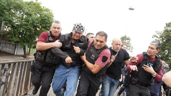 Así evacuaban a Sergio Berni tras el ataque a golpes en la protesta por el crimen del colectivero (Foto: Maxi Failla / Clarín)