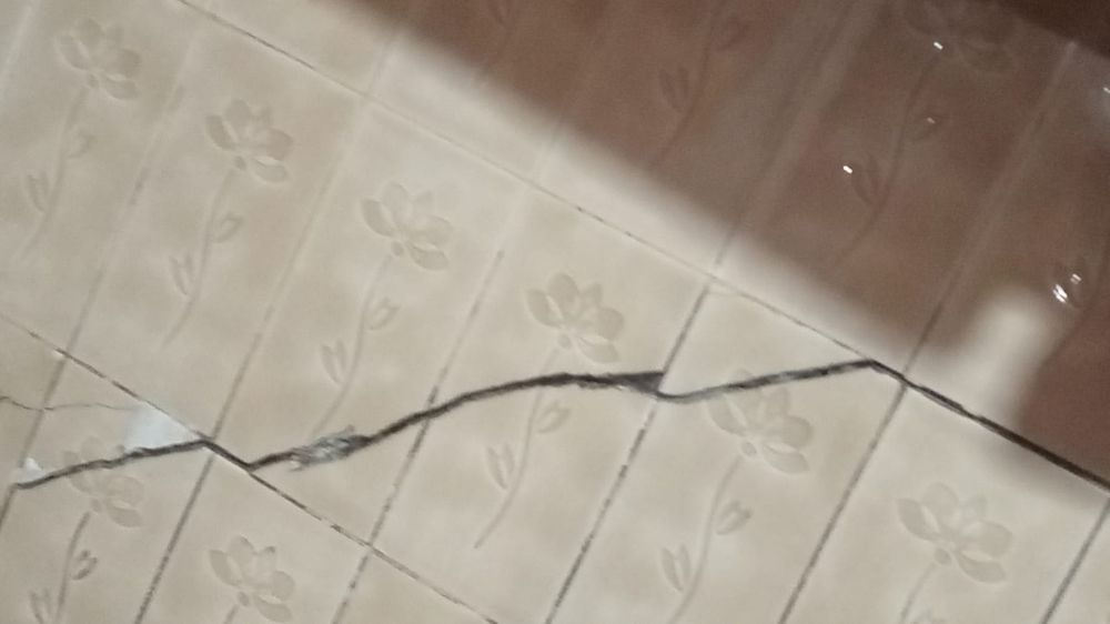 Cracks in the walls reflect structural damage caused by soil loss.