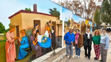 Arte en una finca. Escena de las patricias mendocinas y religiosas confeccionando la bandera del Ejército de Los Andes. A la derecha, los autores del mural y alumnas de la Escuela de Artes Plásticas de la UNCuyo.