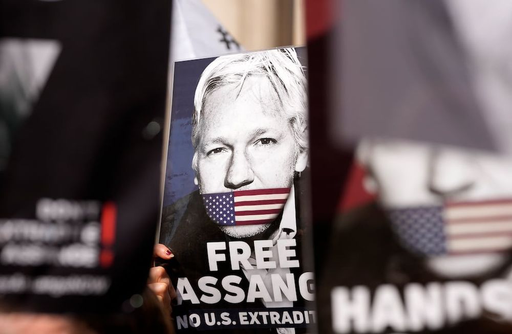 Manifestantes colocan carteles ante el Alto Tribunal en Londres, el lunes 20 de mayo de 2024. Una corte británica determinó el lunes que el fundador de WikiLeaks Julian Assange puede apelar su extradición a Estados Unidos por cargos de espionaje. (AP Foto/Kin Cheung)