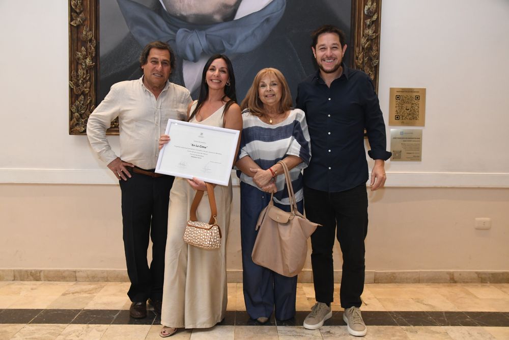 Laura Rez Masud, happy with the award and celebrating with her family.