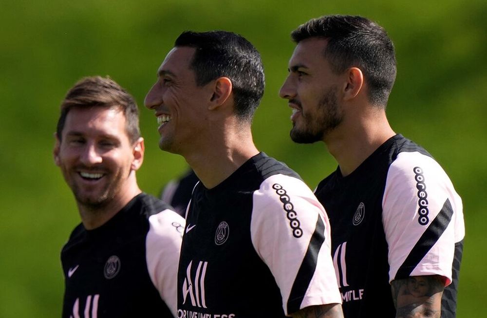 Lionel Messi, left, Angel di Maria, center and Leandro Paredes arrive at the Paris Saint-Germain training camp in Saint-Germain-en-Laye, west of Paris, Friday, Aug. 13, 2021 The 34-year-old Argentina star arrived Tuesday in Paris to sign a two-year deal with the option for a third season with PSG after leaving Barcelona. (AP Photo/Francois Mori)