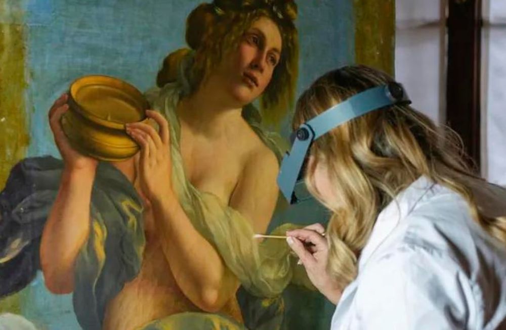 La restauradora Elizabeth Wicks trabaja en la Alegoría de la Inclinación, una obra de 1616 de Artemisia Gentileschi (AP Photo/Andrew Medichini)