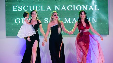Los Andes | Brisa, a la izquierda, desfila con Isabella en brazos, en la fiesta de promoción 2021 de quinto año del Nacional de San Martín. En la salida, acompaña a la joven su mejor amiga, Luz (de bordó) y otra compañera.