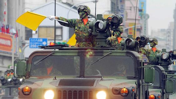 A fleet of Taiwanese military vehicles loading US-made TOW anti-tank missiles, run through the Office of President during a rehearsal for National Day celebrations, Monday, Oct. 8, 2007, in Taipei, Taiwan. War planes, armored personnel carriers and other weapon systems will be displayed Wednesday during the National Day military parade. (AP Photo/Chiang Ying-ying)