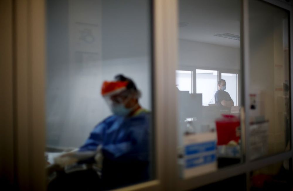 Un trabajador del área de terapia intensiva de un hospital de Buenos Aires atiende a un paciente. Natacha Pisarenko / AP
