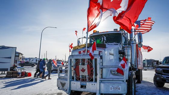 The last truck blocking the southbound lane moves after a breakthrough resolved the impasse where anti-COVID-19 vaccine mandate demonstrators blocked the highway at the busy U.S. border crossing in Coutts, Alberta, Wednesday, Feb. 2, 2022. (Jeff McIntosh /The Canadian Press via AP)