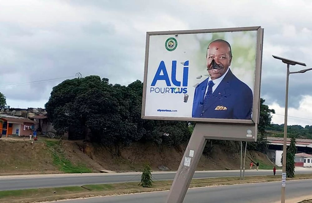 Un cartel roto del presidente de Gabón, Ali Bongo Ondimba, en una calle de Libreville, Gabón, el 30 de agosto de 2023, el mismo día que fue derrocado. (Foto AP/Yves Laurent, archivo)