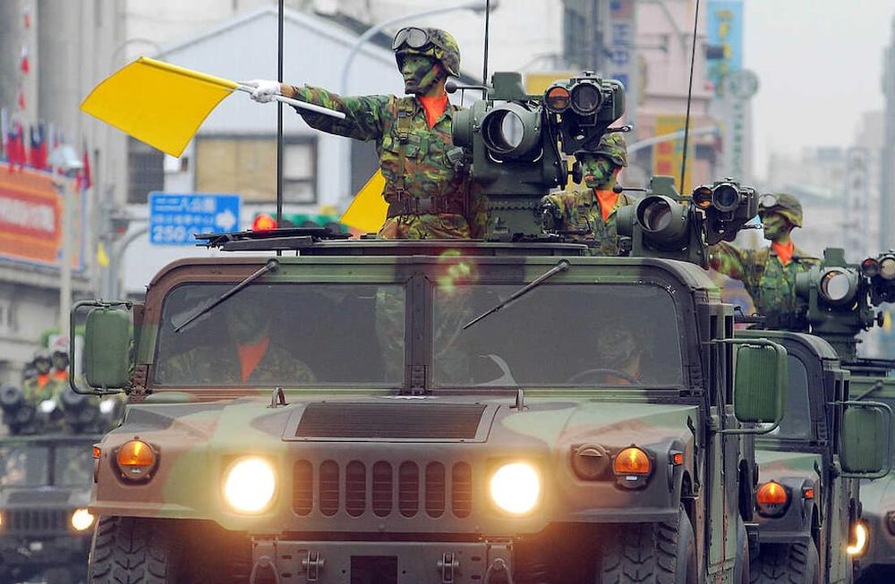 A fleet of Taiwanese military vehicles loading US-made TOW anti-tank missiles, run through the Office of President during a rehearsal for National Day celebrations, Monday, Oct. 8, 2007, in Taipei, Taiwan. War planes, armored personnel carriers and other weapon systems will be displayed Wednesday during the National Day military parade. (AP Photo/Chiang Ying-ying)