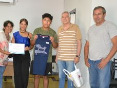Genaro Cueito (centro) recibe una remera. Primera, a la izquierda, su madre Lorena Castro. Al lado de genaro, a la derecha, el delegado municipal de Palmira Ángel Bottero.&nbsp;