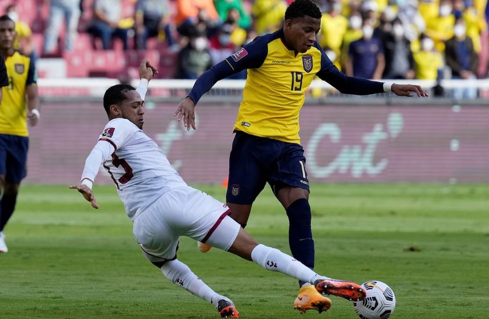 Gonzalo Plaza, de Ecuador, intenta ante José Martínez, de Venezuela, en un partido de las eliminatorias sudamericanas. (AP)