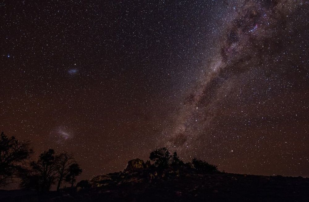 Las Nubes de Magallanes (izquierda de la foto) pueden apreciarse en el cielo nocturno del Hemisferio Sur. Estas dos galaxias están acercándose en su primer viaje hacia la Vía Láctea (derecha de la foto).